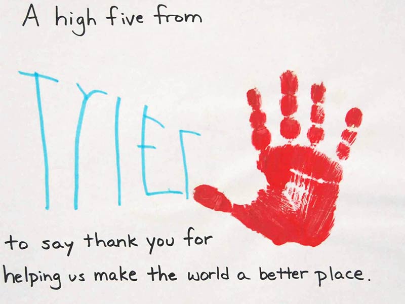 A child's red hand print with black and cyan marker