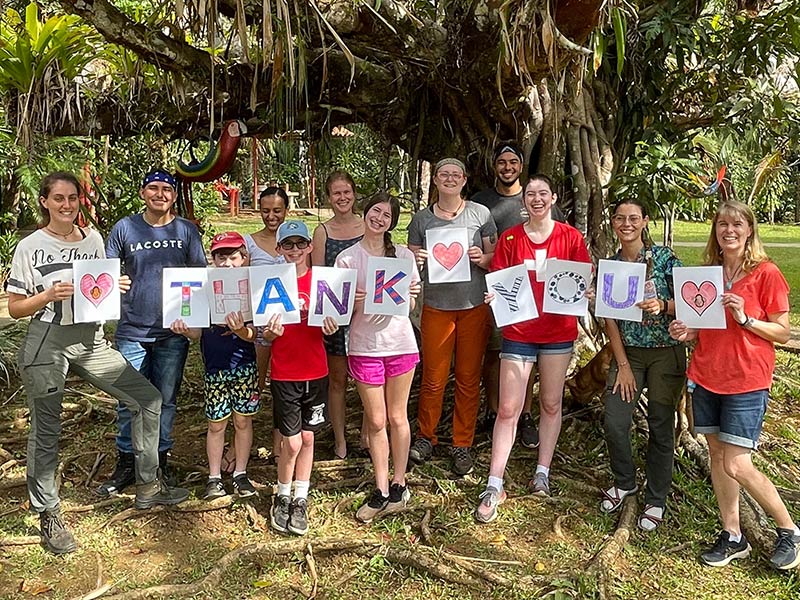 Photo of a group of people holding up letters that say thank you